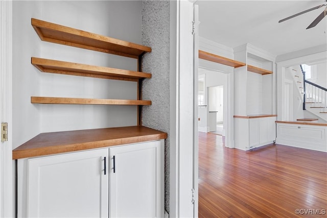 interior space featuring dark wood-style floors, stairs, and a ceiling fan