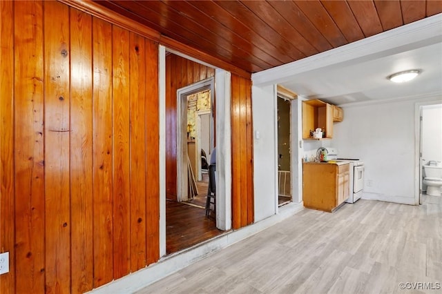 hall with wooden walls, wooden ceiling, and light wood-style floors