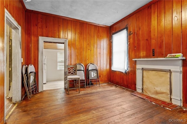 living area featuring hardwood / wood-style floors and wooden walls