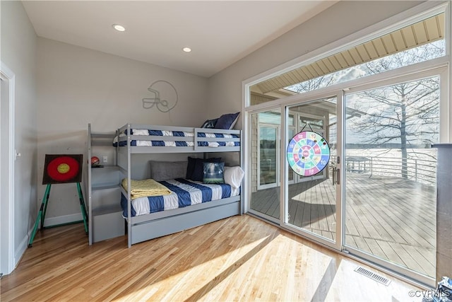 bedroom featuring access to exterior, wood finished floors, visible vents, and recessed lighting