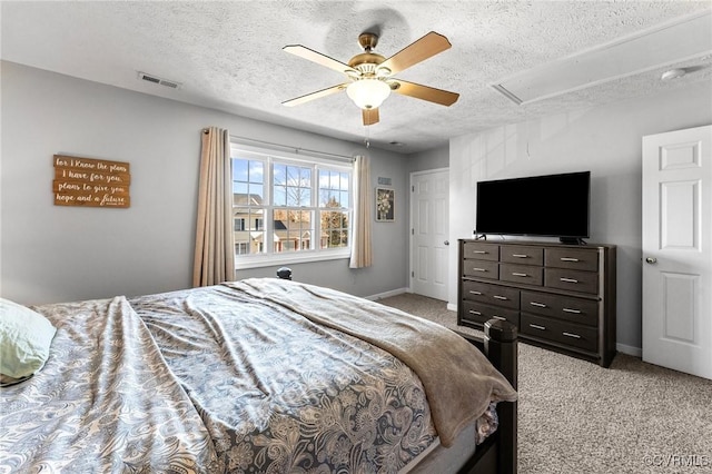 bedroom featuring baseboards, a textured ceiling, visible vents, and light colored carpet