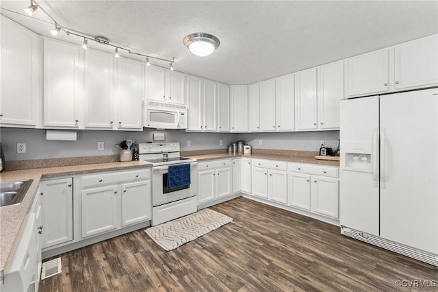 kitchen featuring white appliances, white cabinets, dark wood-type flooring, and light countertops