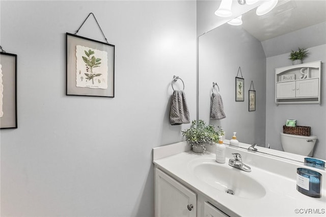 half bath featuring toilet and vanity