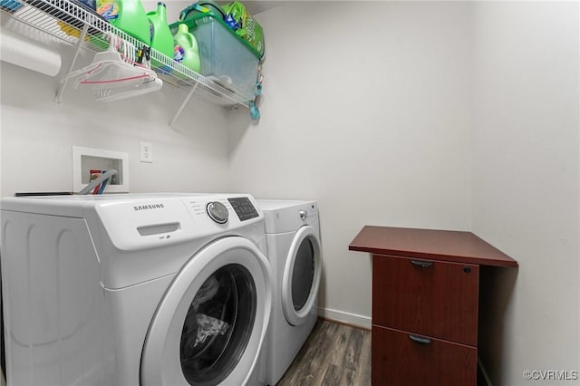 laundry area featuring laundry area, baseboards, washer and clothes dryer, and dark wood-style flooring