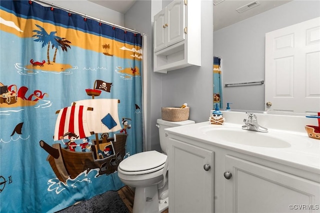 bathroom with toilet, curtained shower, vanity, and visible vents