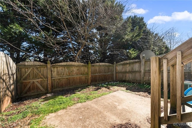 view of yard featuring fence and a patio