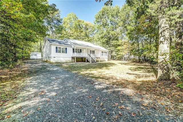 manufactured / mobile home with driveway, crawl space, and a porch