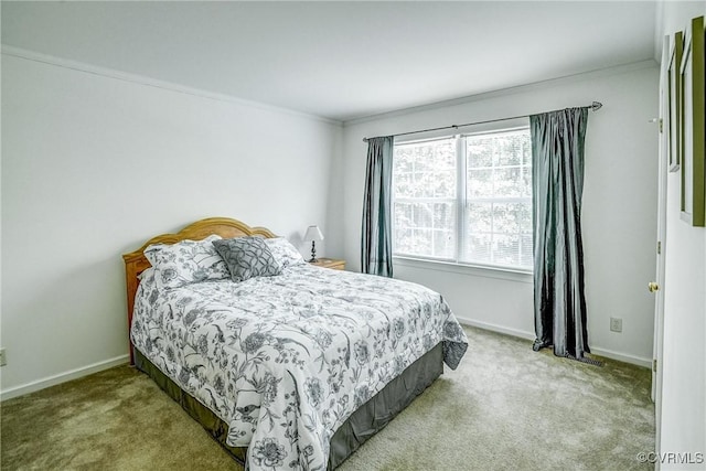 bedroom with ornamental molding, light carpet, and baseboards