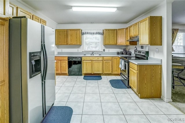 kitchen featuring light tile patterned floors, under cabinet range hood, a sink, light countertops, and appliances with stainless steel finishes