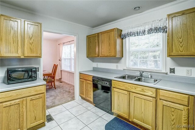 kitchen featuring crown molding, light tile patterned floors, light countertops, a sink, and black appliances