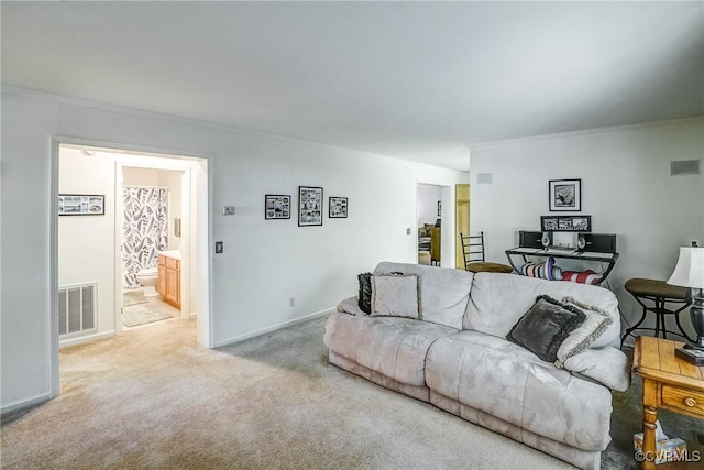 living room featuring visible vents, light carpet, and baseboards