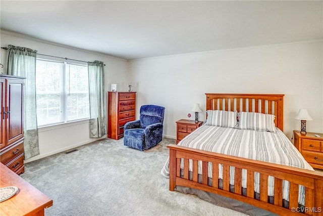 bedroom featuring baseboards, visible vents, and light colored carpet