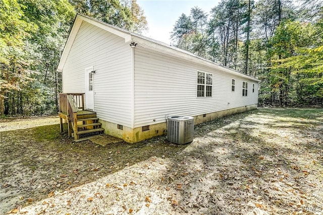 view of property exterior with central AC unit and crawl space