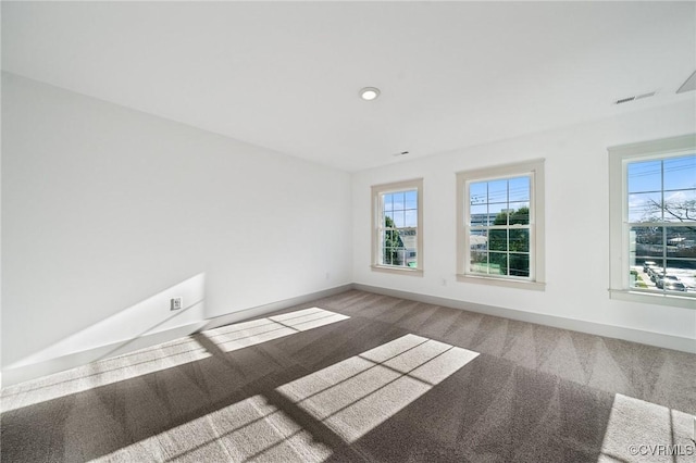 spare room featuring recessed lighting, carpet flooring, visible vents, and baseboards