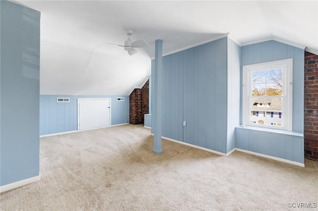 additional living space featuring a ceiling fan, carpet, visible vents, and lofted ceiling