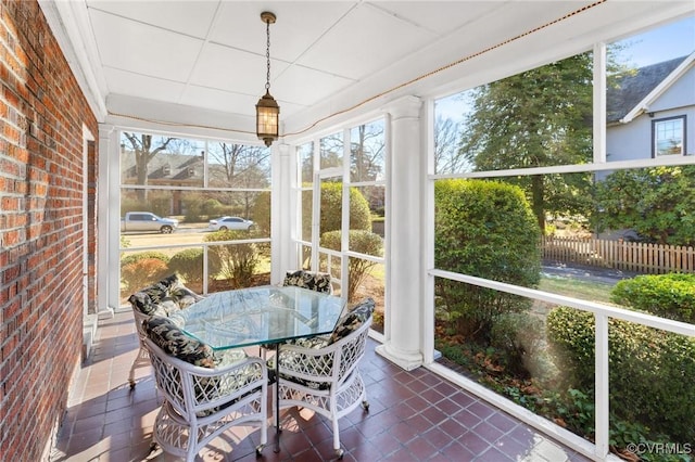 sunroom / solarium featuring ornate columns