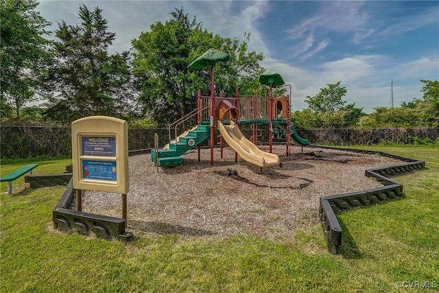 community playground featuring a yard and fence