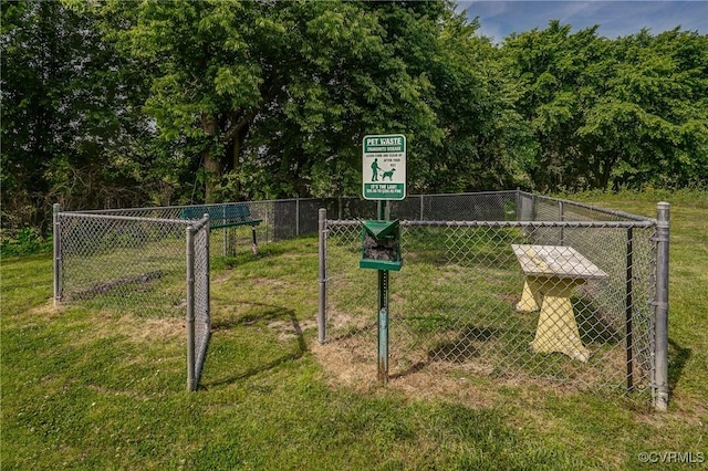 surrounding community with fence and a yard