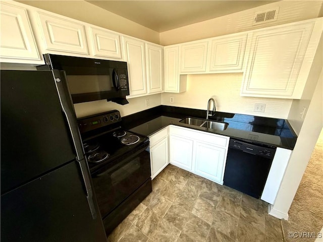 kitchen featuring visible vents, a sink, black appliances, white cabinets, and dark countertops