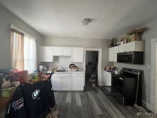 kitchen featuring white cabinetry, light countertops, electric range oven, and wood finished floors