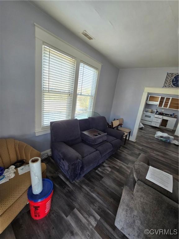 living room with dark wood-type flooring and visible vents