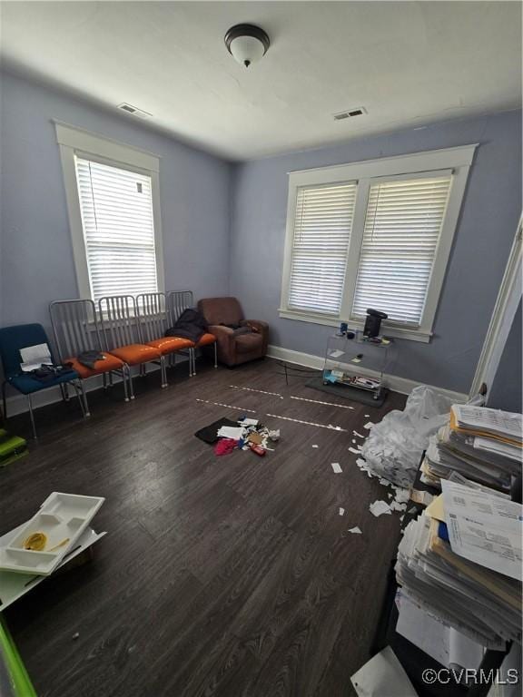 interior space featuring dark wood-style flooring, visible vents, and baseboards