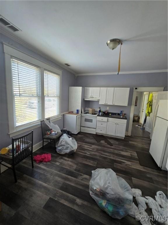 kitchen featuring white appliances, visible vents, white cabinets, ornamental molding, and dark wood-type flooring