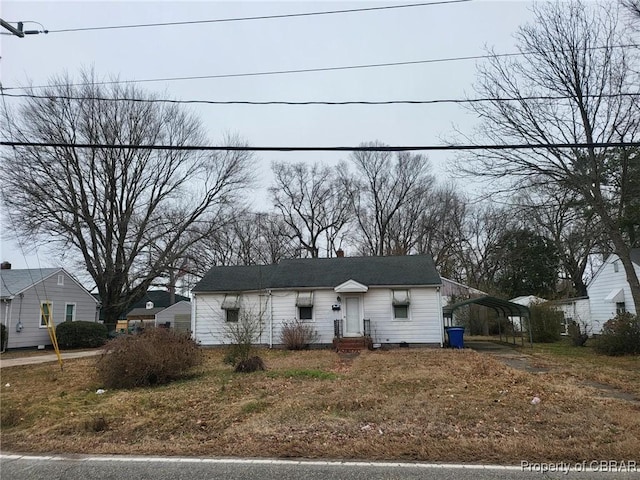 view of front of home featuring driveway and a carport