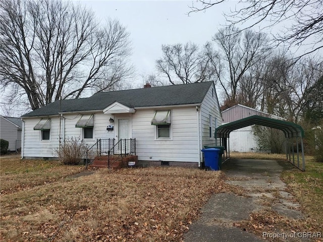 bungalow featuring a carport, crawl space, a chimney, and roof with shingles