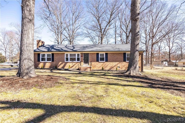 view of front of property featuring entry steps, crawl space, brick siding, and a chimney