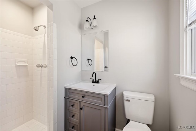 bathroom featuring a stall shower, vanity, and toilet