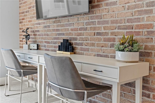 unfurnished office with brick wall