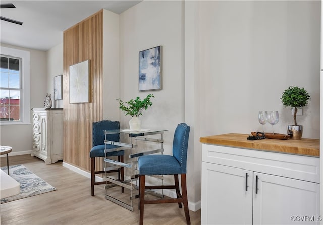 dining space with light wood-style floors and baseboards