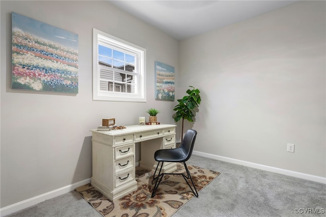 office space featuring light carpet and baseboards