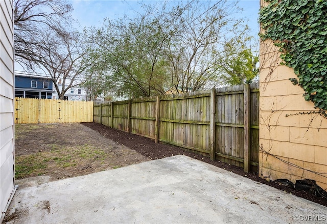 view of yard featuring fence private yard and a patio area