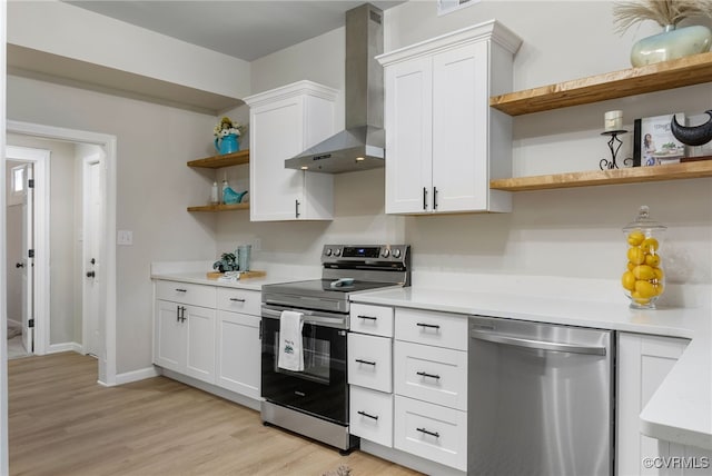 kitchen featuring open shelves, light countertops, appliances with stainless steel finishes, white cabinets, and wall chimney exhaust hood