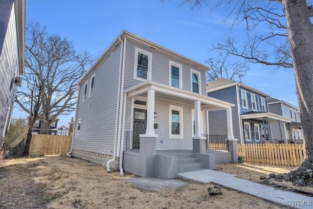 traditional style home with fence and a porch