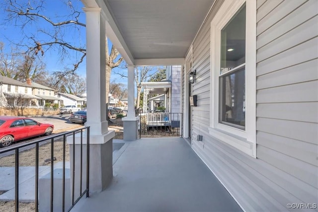 view of patio featuring a porch and a residential view