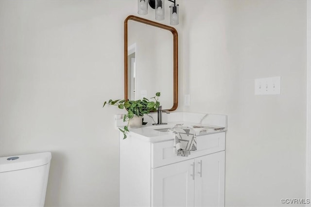 half bathroom with vanity and toilet