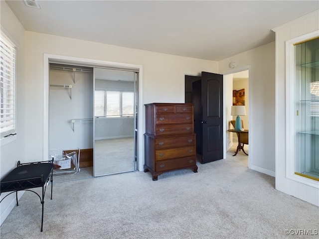 bedroom featuring light carpet and a closet