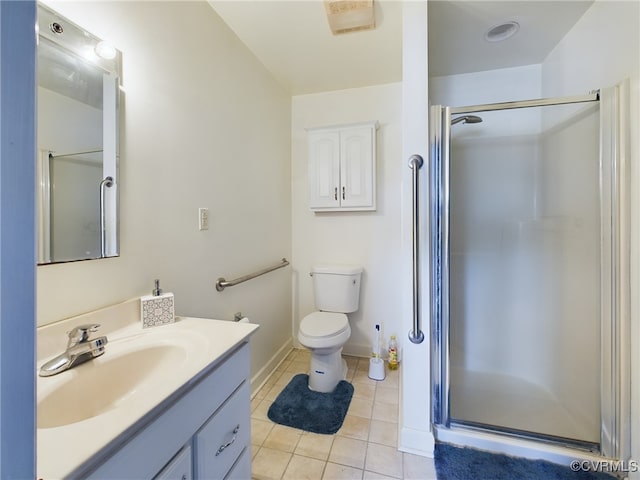 bathroom with toilet, a stall shower, vanity, baseboards, and tile patterned floors