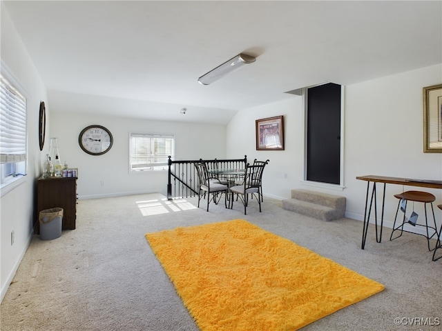 sitting room featuring baseboards, light colored carpet, and an upstairs landing