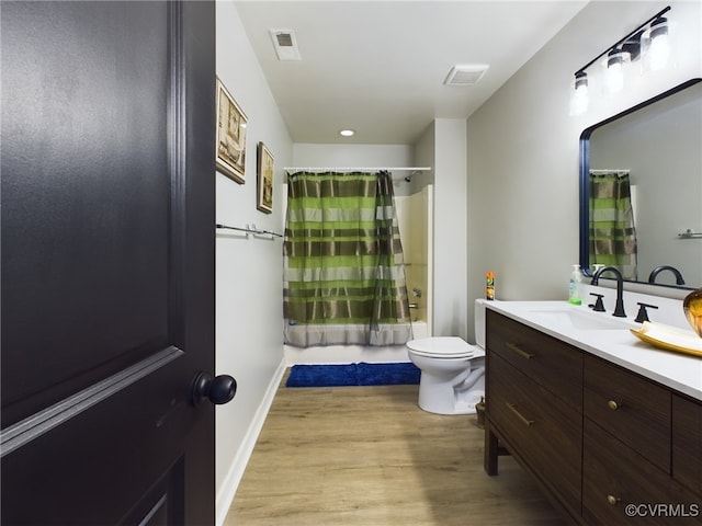 full bathroom featuring wood finished floors, visible vents, toilet, and shower / bath combo with shower curtain