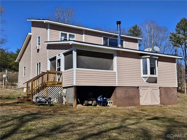 back of house with a lawn and a sunroom