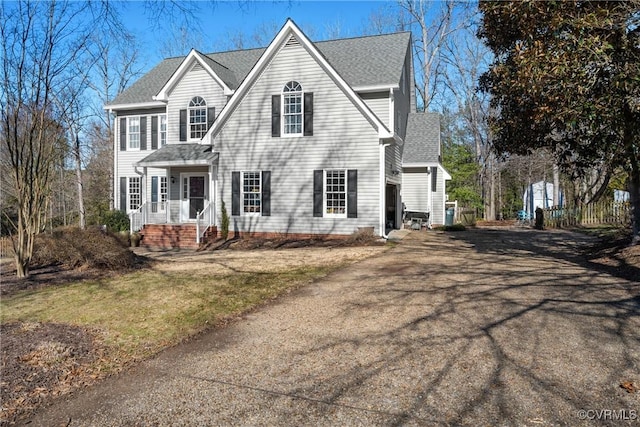 view of front of property with aphalt driveway and roof with shingles