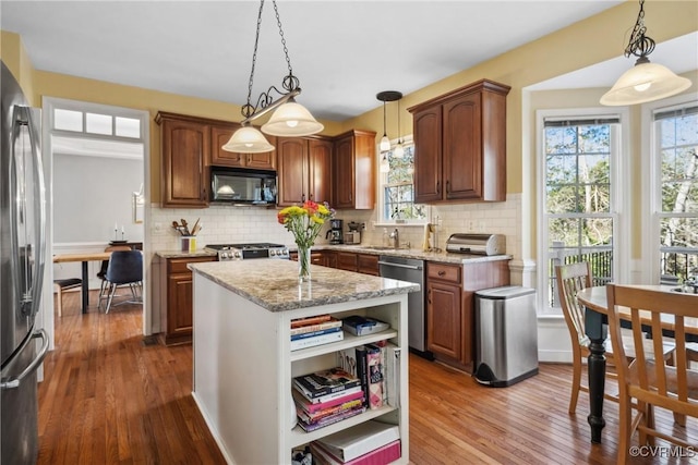 kitchen with backsplash, dark wood-type flooring, light stone counters, appliances with stainless steel finishes, and open shelves