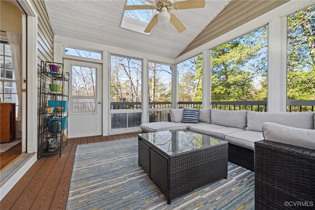 sunroom with vaulted ceiling and a ceiling fan