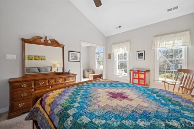 carpeted bedroom featuring visible vents, high vaulted ceiling, and ceiling fan