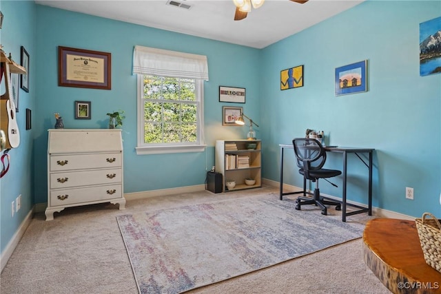 home office with visible vents, baseboards, carpet floors, and a ceiling fan