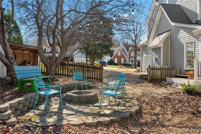 view of yard featuring a patio, a fire pit, and fence